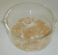 Raw pine rosin in glass dish